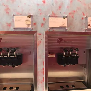 two soda machines with labels on them