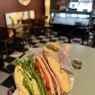 a sandwich with lettuce, tomato, and cheese