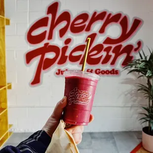  a person holding a drink