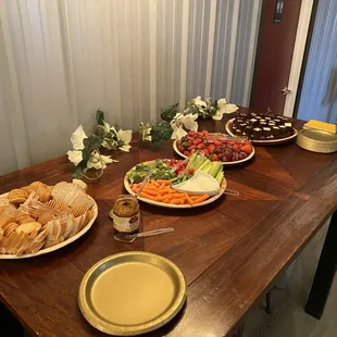a wooden table with plates of food on it