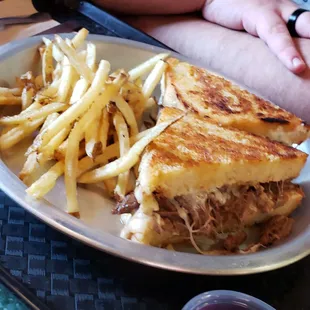 Pot roast grilled cheese and fries.