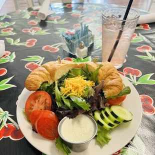 California club sandwich with a salad and raspberry lemonade