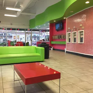 a bright green couch and red coffee table