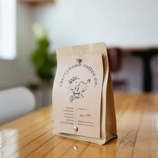 a bag of coffee on a wooden table