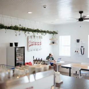 a person sitting at a table in a coffee shop