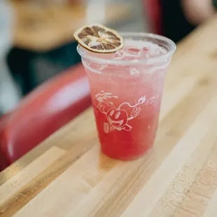 a drink with a slice of lemon on top