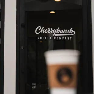 a cup of coffee in front of a window