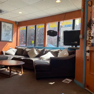 a living room with a couch, coffee table, and television