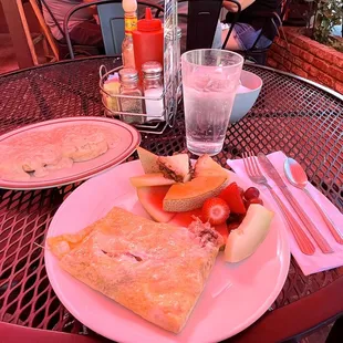 Sausage &amp; Swiss cheese omelette with fruit and biscuits and gravy.