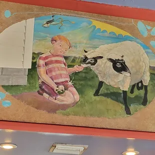 a boy feeding a sheep