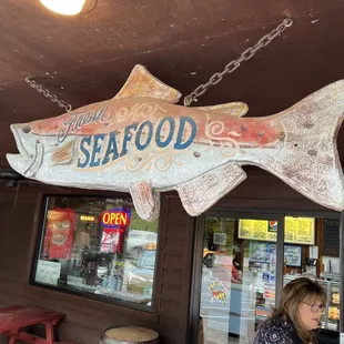 a woman standing in front of the restaurant