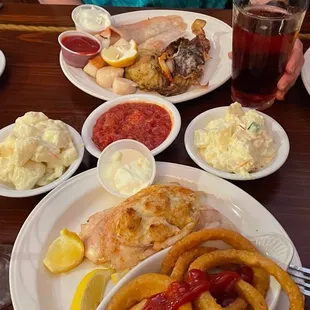 Top: seafood combo, clams, stewed fresh tomatoes lower: crab stuffed flounder, onion rings, prosecco, potato salad