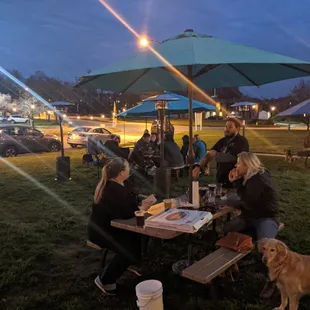 a group of people sitting at a picnic table