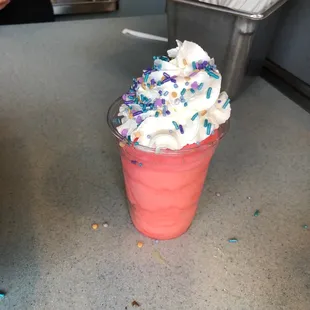 a cup of ice cream with sprinkles