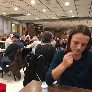 a woman sitting at a table in a restaurant