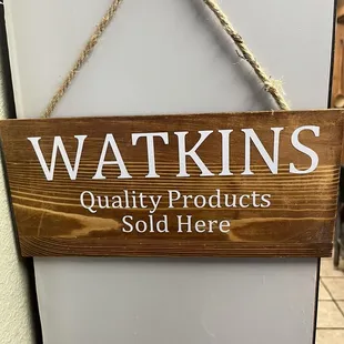a sign for watkinss quality products sold here