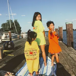 three children on a dock