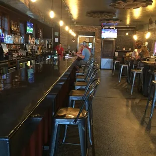 a long bar with stools
