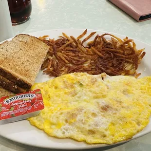 Shrimp, crab, green pepper and cheese omelet with a hash brown and whole wheat toast
