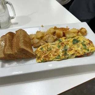 Vegetable omelet with wheat toast and home fries