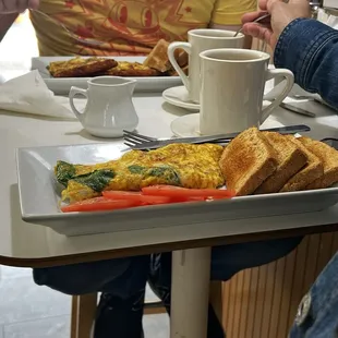 Spinach omelet with wheat toast and tomato slices