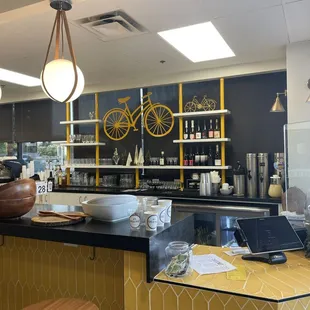 a yellow bar with a bicycle on the wall