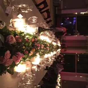 a long table with candles and flowers