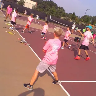 Stretching before some tennis at Coach Conroy&apos;s All Sports Camp.