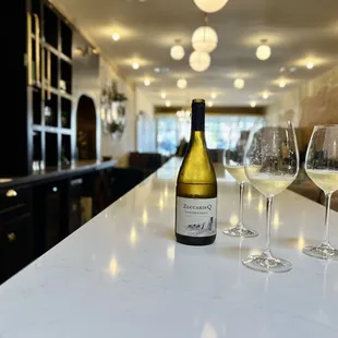 a bottle of wine and two glasses of wine