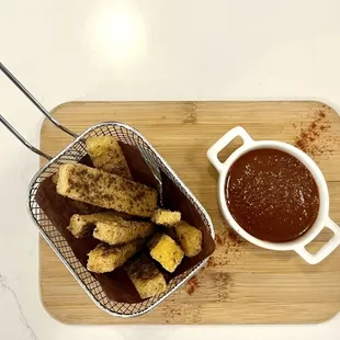 a basket of breadsticks and a cup of coffee