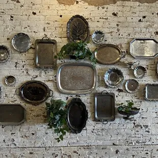 a brick wall with a variety of dishes on it