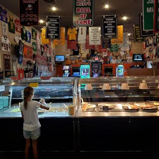 a little girl standing in front of the counter