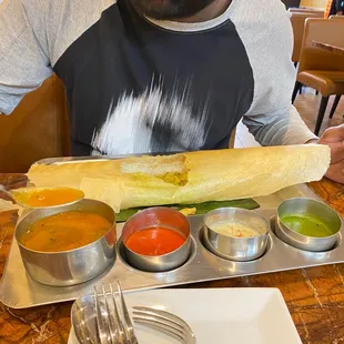 a man sitting at a table with a plate of food