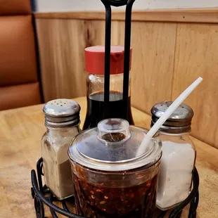 a table with condiments and salt and pepper shakers