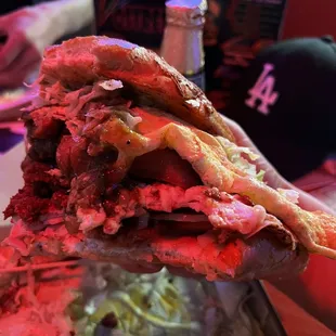 a hand holding a sandwich