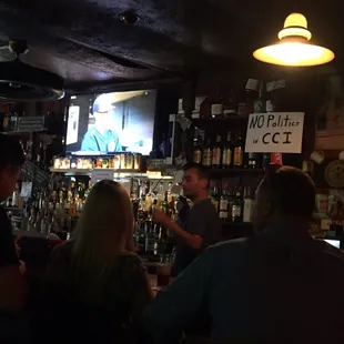 a man on a television in a bar
