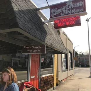 a woman sitting at a table outside