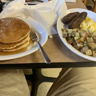 Pancakes, home fries, eggs and link sausage.