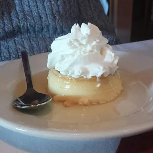 Flan like pudding with whipped cream.