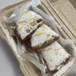 three pieces of cake in a styrofoam container