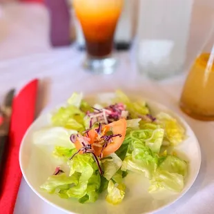 a plate of salad and a drink