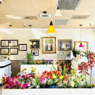 a flower shop with flowers in the foreground