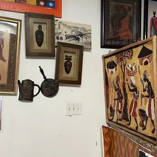 a kitchen with a refrigerator and pictures on the wall