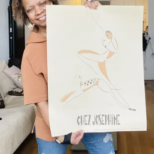 a woman holding a poster