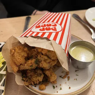 a plate of fried food and a cup of sauce
