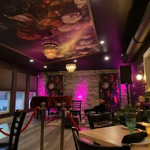 a dining room with purple lighting