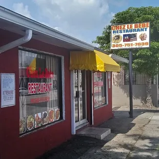 a red building with a yellow awning