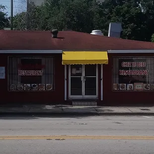 a red building with a yellow awning