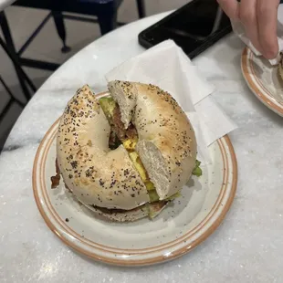 Delicious bagel with avacado, egg, and bacon