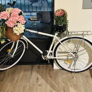a bicycle with a basket of flowers
